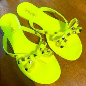 Neon yellow jelly flip flops
